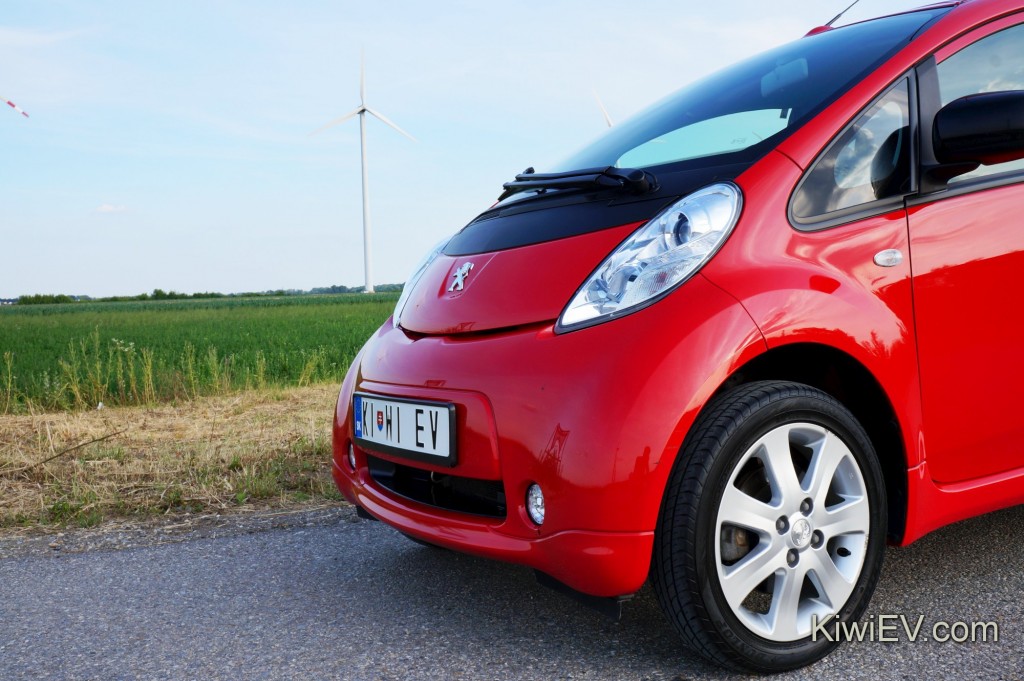 Electric car in front of wind turbine